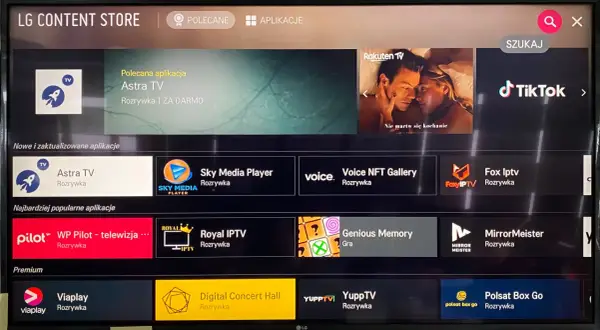 Ekran LG Content Store. Widoczne są aplikacje takie jak Astra TV, Sky Media Player, Voice NFT Gallery, Fox Iptv, WP Pilot, Royal IPTV, Genious Memory, MirrorMeister, ViaPlay, Digital Concert Hall, YuppTV, Polsat Box Go. Możesz tu łatwo dowiedzieć się, ...