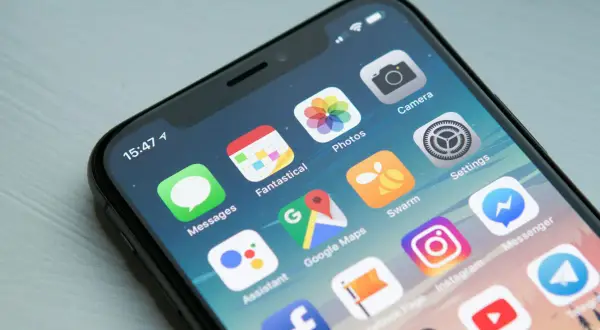Ekran iPhone z ikonami aplikacji. Dowiedz się, jak wyłączyć aplikacje w tle iPhone, aby oszczędzać baterię.