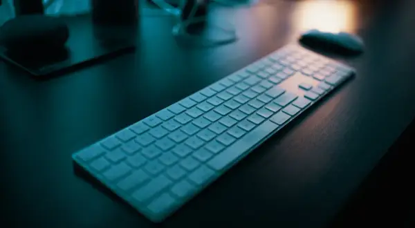 Klawiatura na biurku, gotowa do pracy. Dowiedz się, jak napisać ź na laptopie, by ułatwić sobie pisanie.