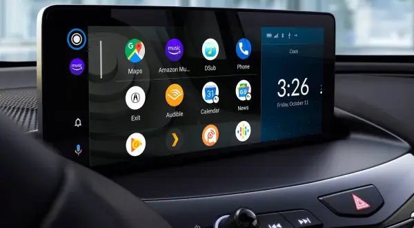 Ekran samochodu z ikonami aplikacji, zegarem i datą. Dowiedz się, jak zaktualizować Android Auto, aby korzystać z najnowszych funkcji.