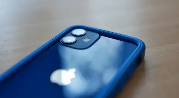 Niebieski iPhone 12 mini w etui. Zastanawiasz się, ile kosztuje iPhone 12 mini? Ten model oferuje świetne funkcje w kompaktowym rozmiarze.